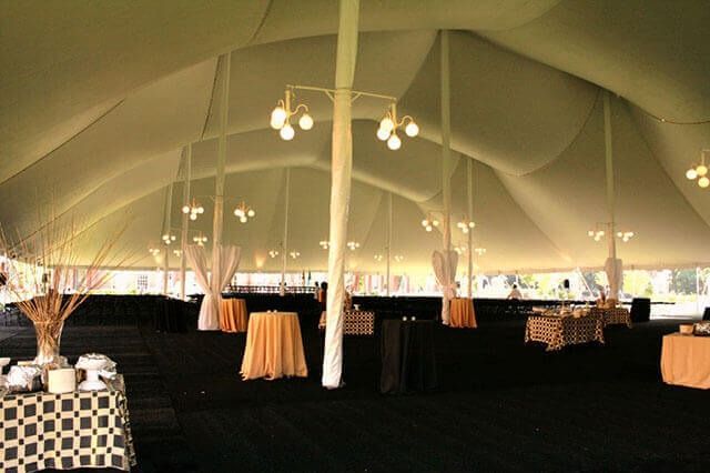 A large tent with tables and chairs inside of it