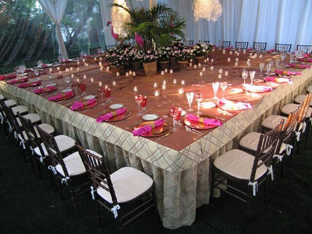 A long table with plates and candles on it