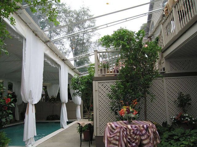 A table with flowers on it in front of a pool