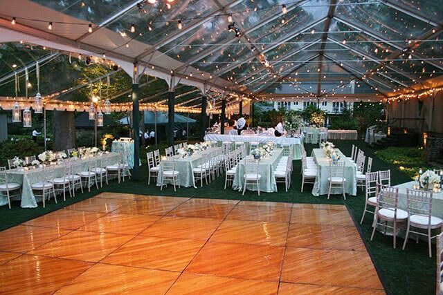 A large tent with tables and chairs underneath it
