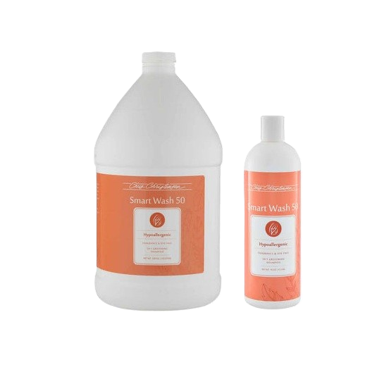 Two white bottles of dog body wash Chris Christensen, one large and one small, with orange labels.