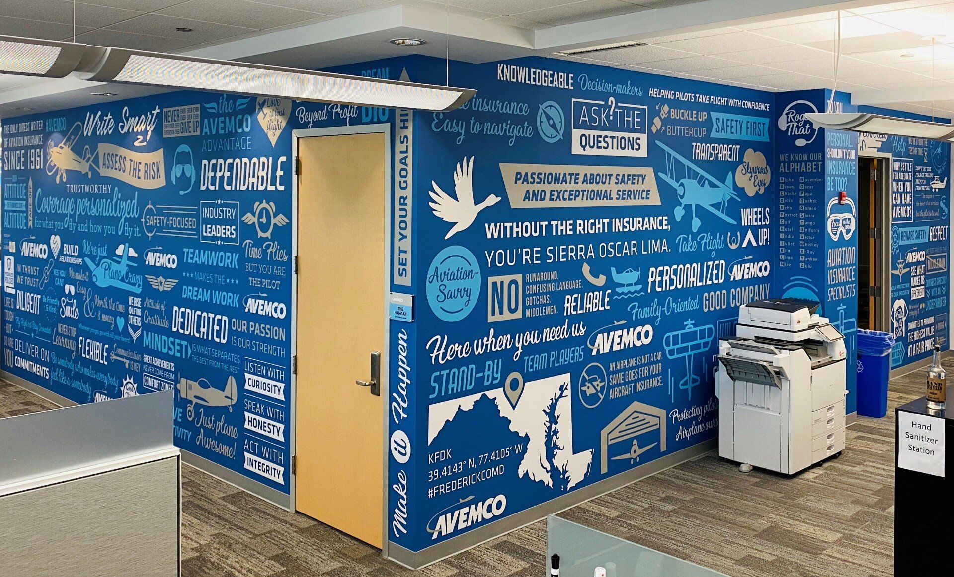 A corner of an office with a mural on the wall