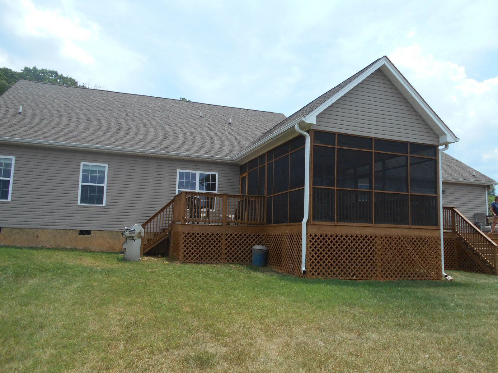 The back of a house with a screened in porch