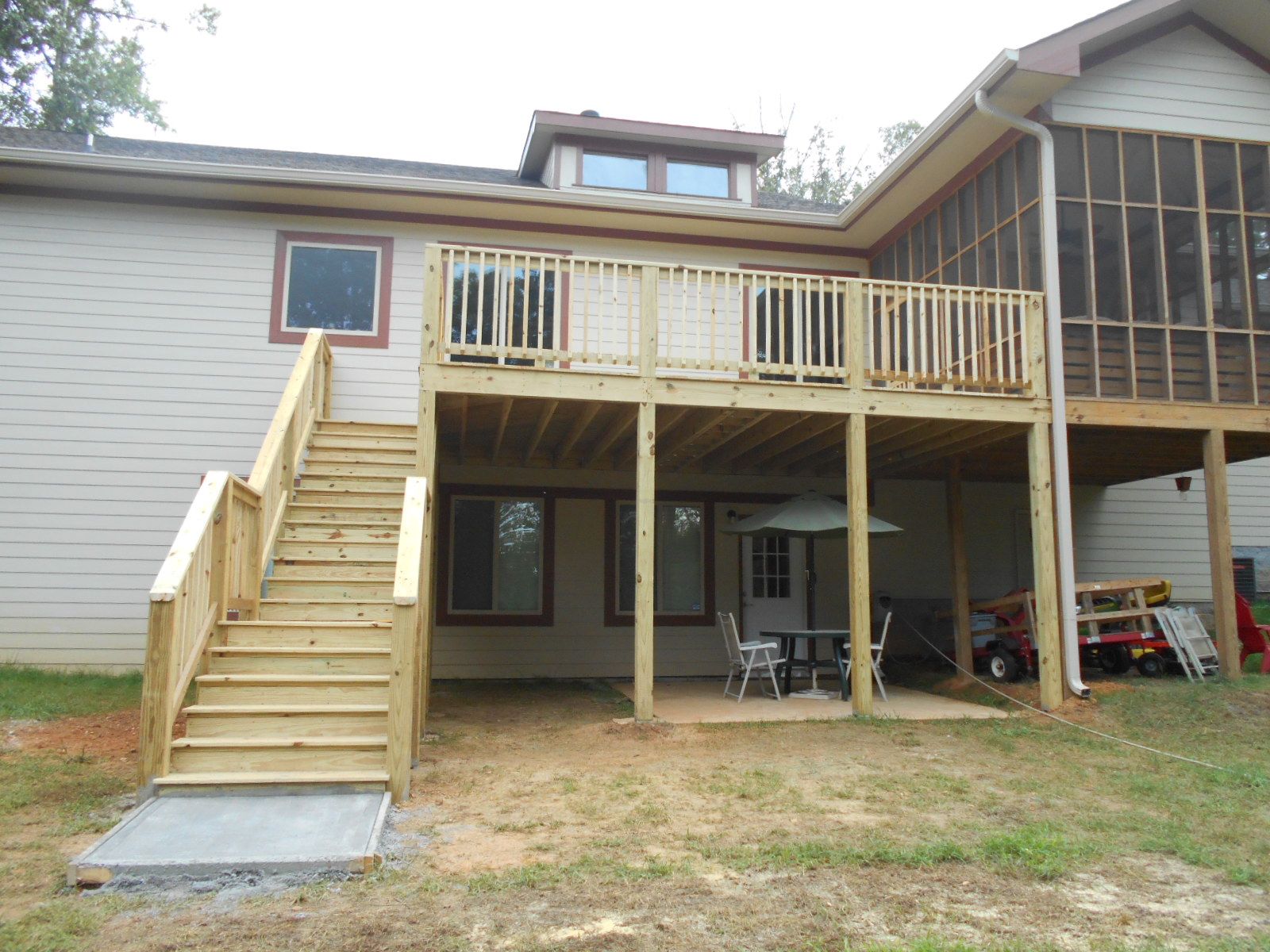 A house with a screened in porch and a wooden deck