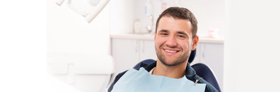 Man smiling on dental chair