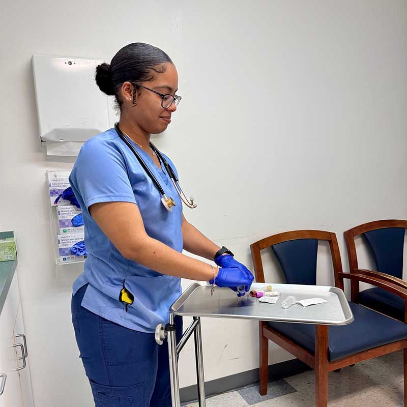 a nurse is standing next to a tray in a waiting room