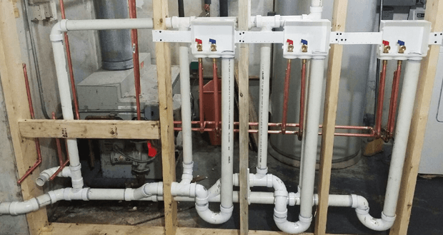 Newly installed copper and PVC pipes with hot and cold water valves