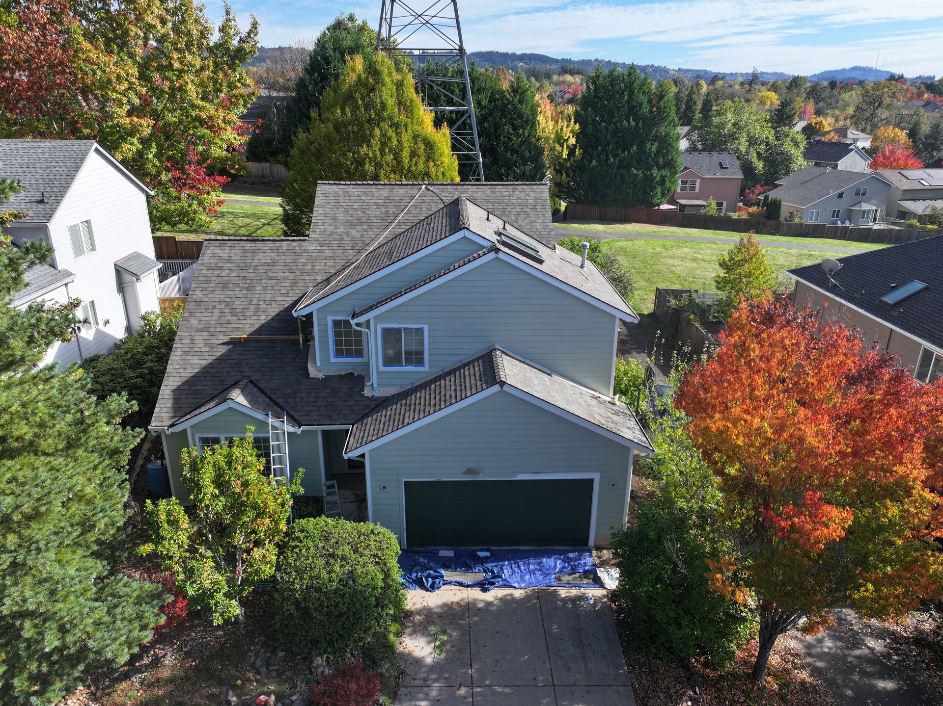 An aerial view of a house with a green garage door