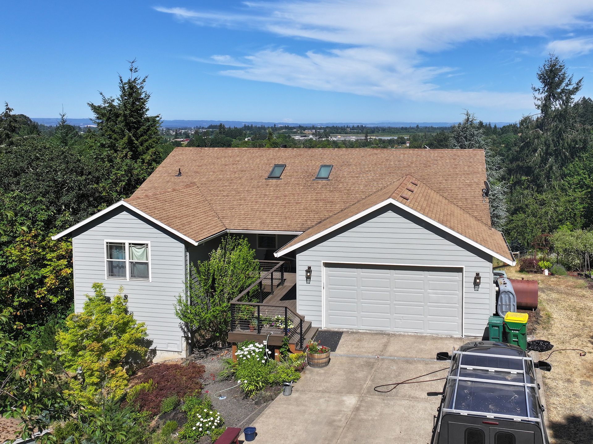 An aerial view of a house with a car parked in front of it