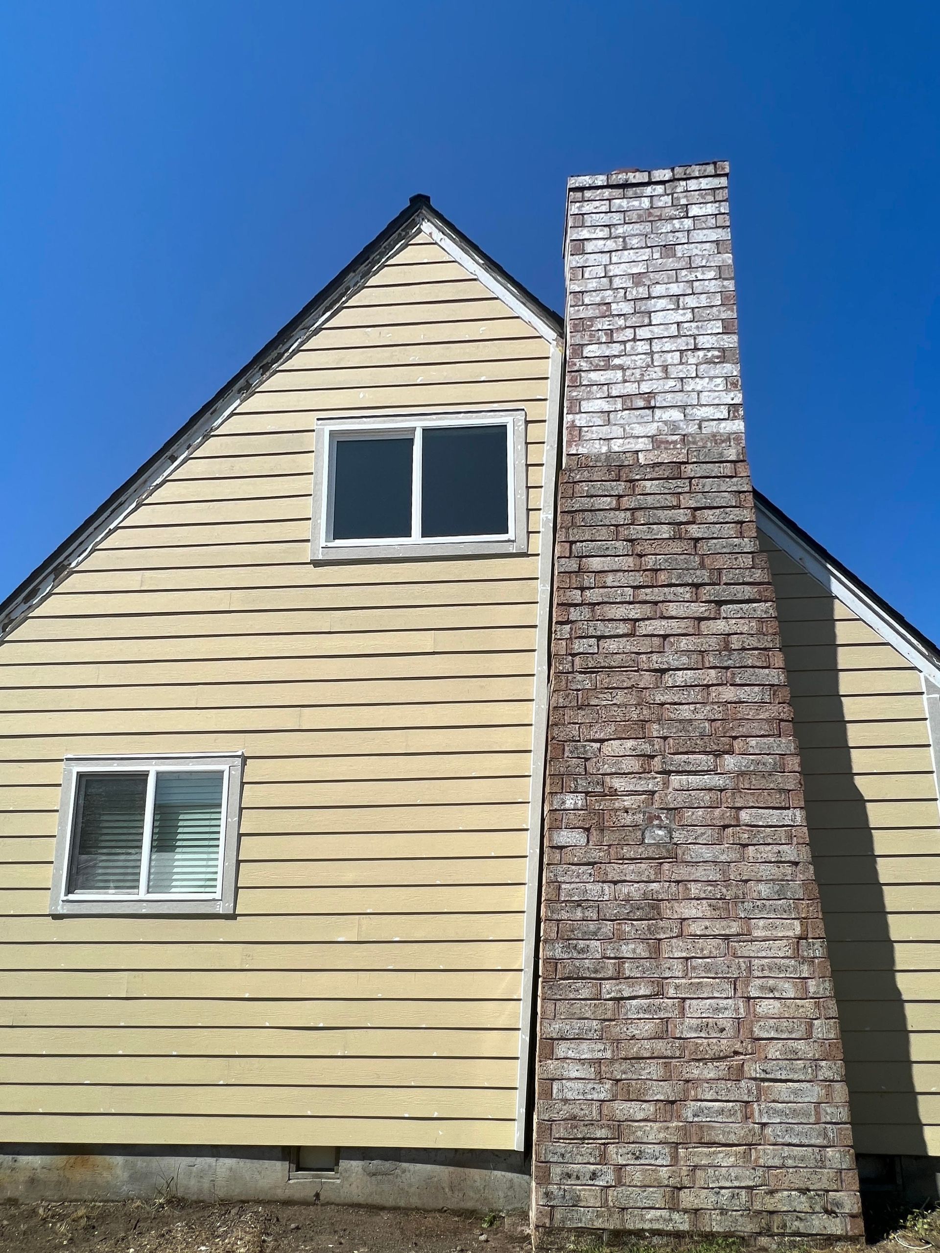 Siding project for a property with chimney during photo