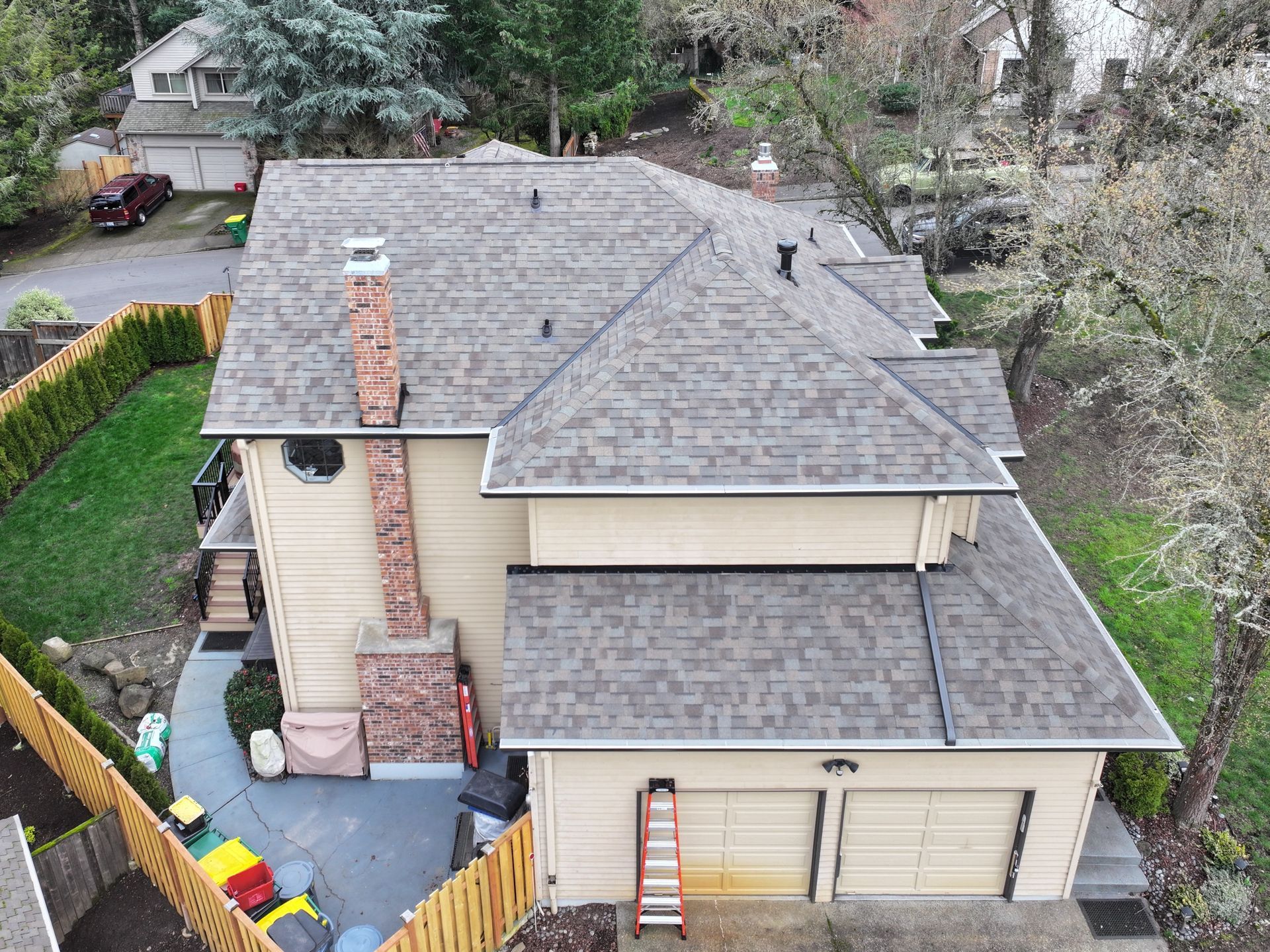 An aerial view of a house with a new roof.