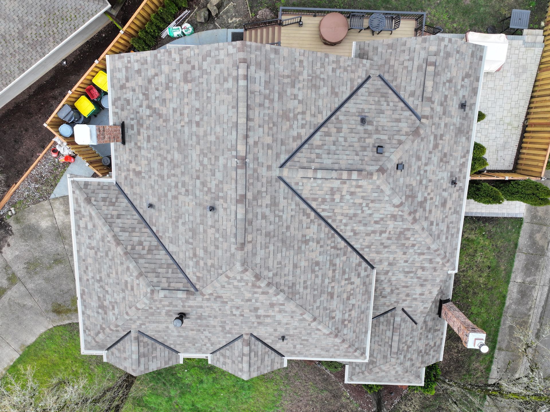 An aerial view of a house with a roof and a patio.