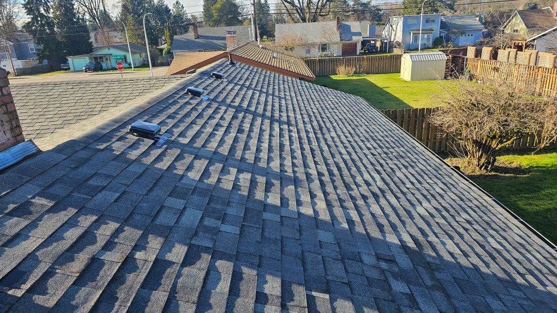 A residential roof after grey tile roofing is completed.