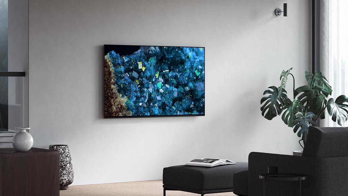 A living room with a flat screen tv hanging on the wall.