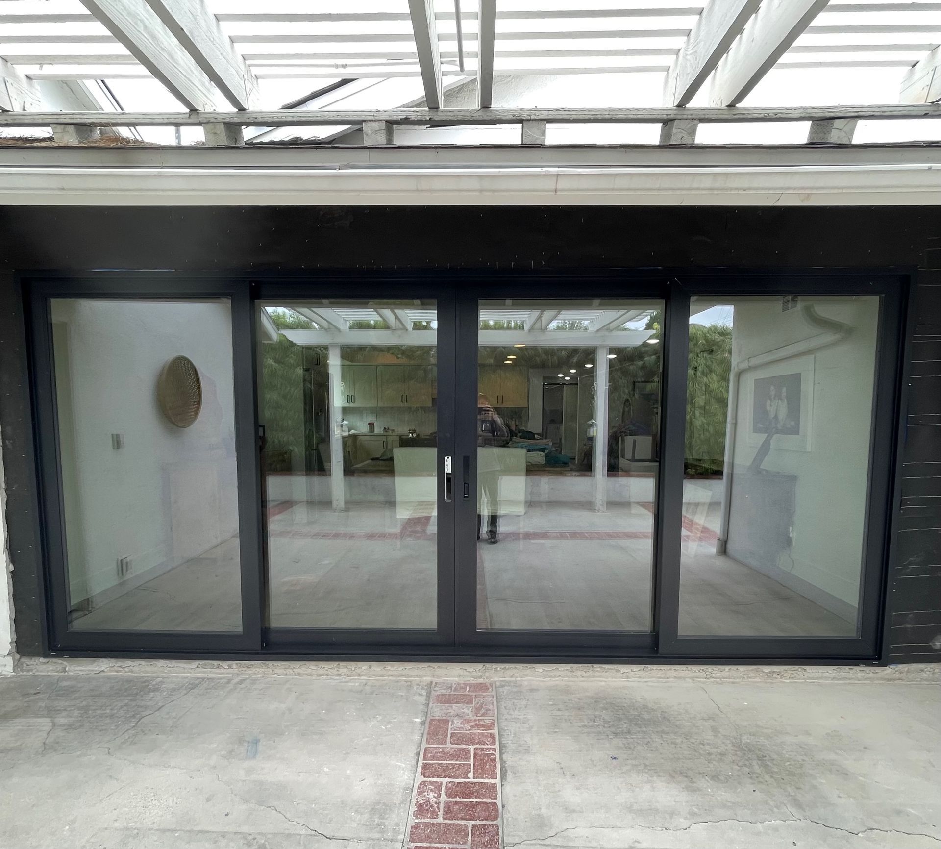 A large sliding glass door is open to a patio.