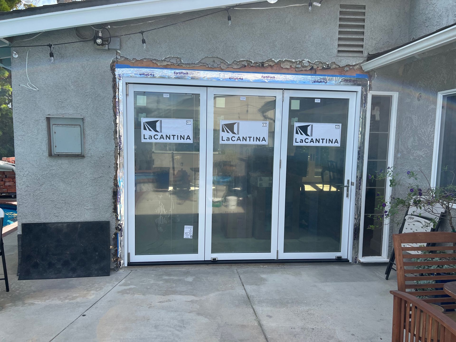 A house with a lot of windows and a sign that says la cantina