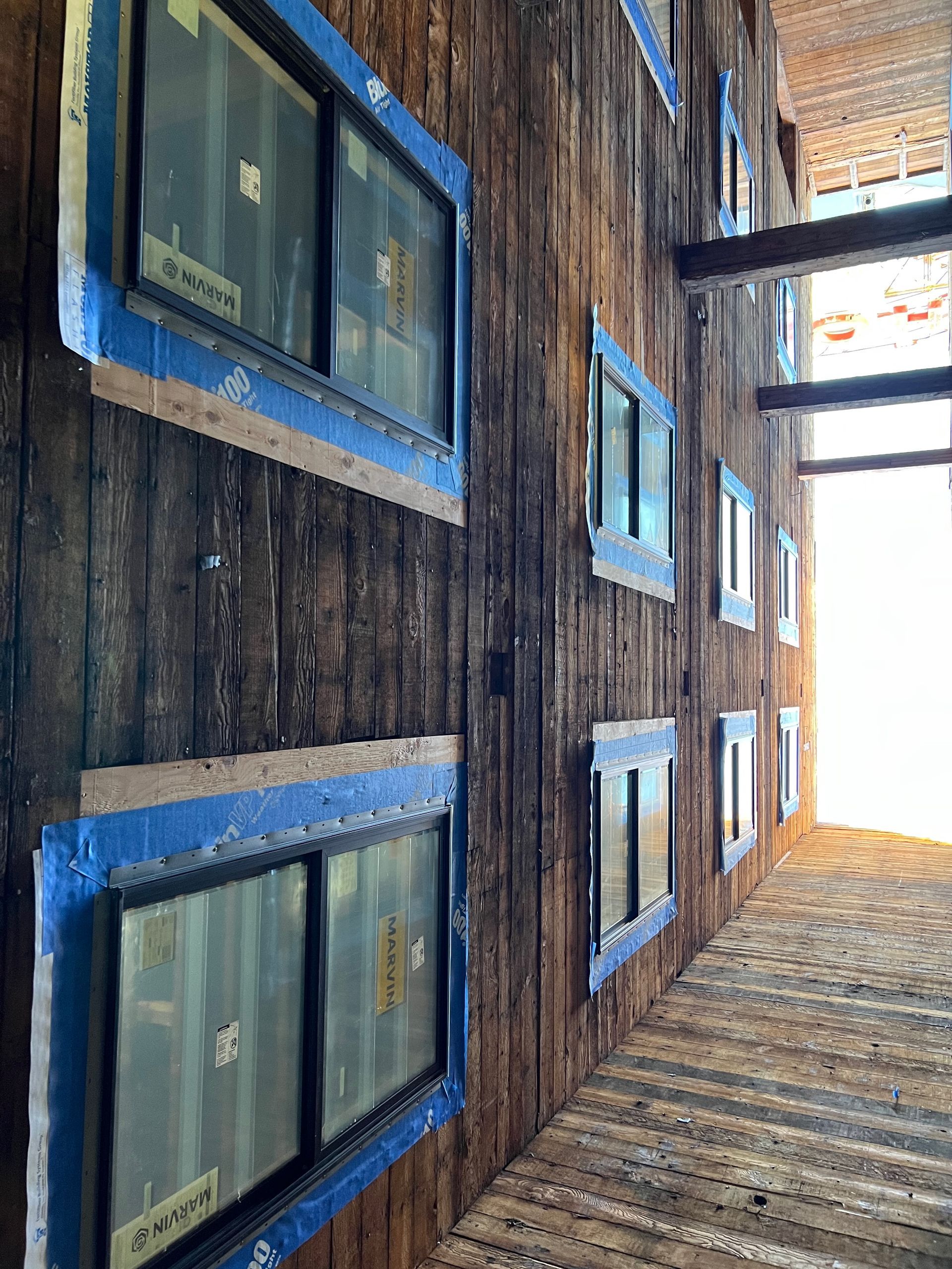 A wooden building with a lot of windows on it.