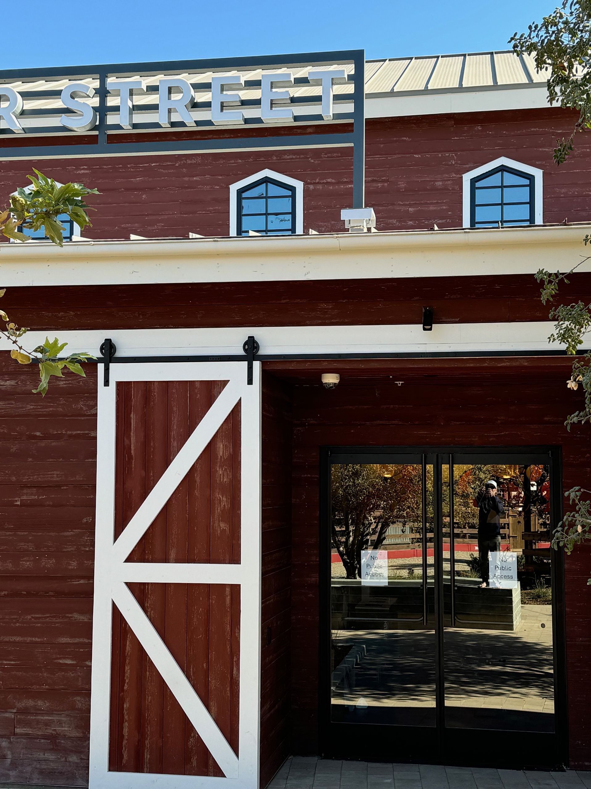A red building with a white sliding barn door