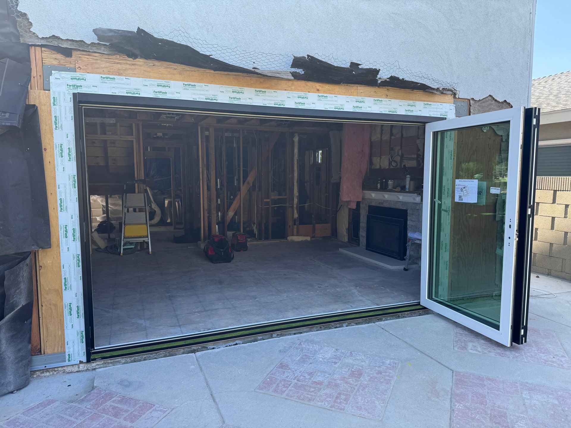 A garage is being remodeled with a sliding glass door.