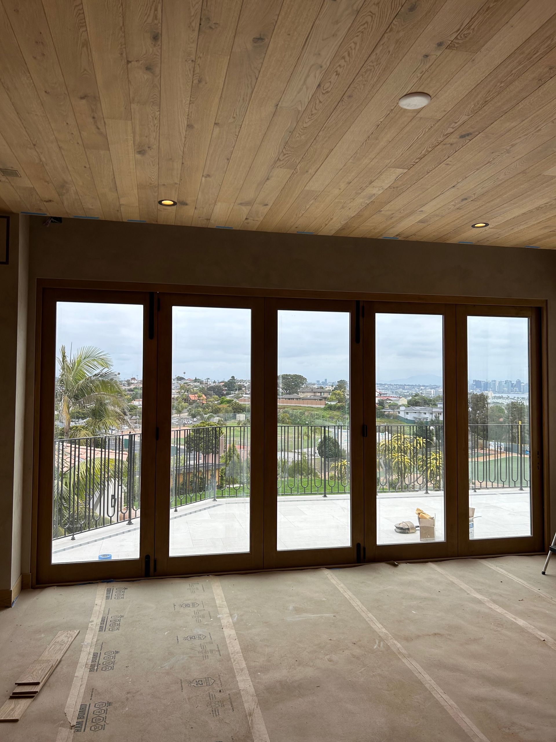 A room with lots of windows and a wooden ceiling