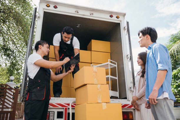 A man stands by a moving truck with boxes, highlighting professional moving services in Lakeville, FL.