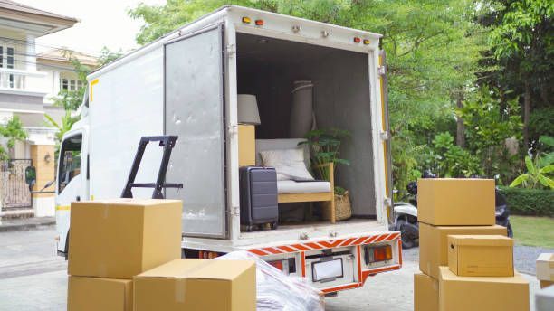 A moving truck loaded with boxes and furniture, ready for transport to a new location.