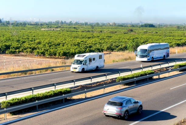 A row of semi trucks parked in a line, ready for long-distance moving services.