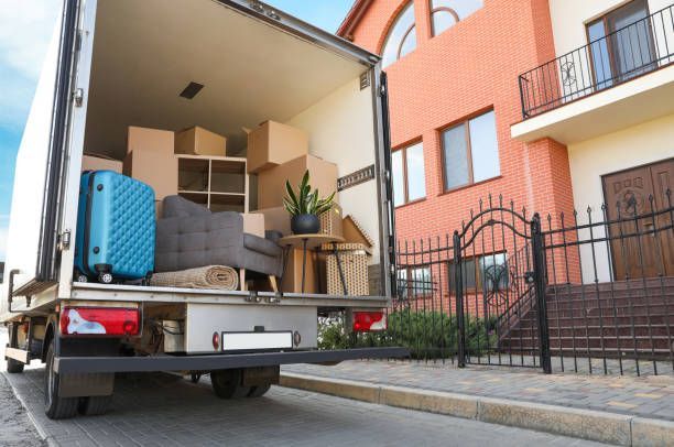 men removing furniture from a moving truck with 
