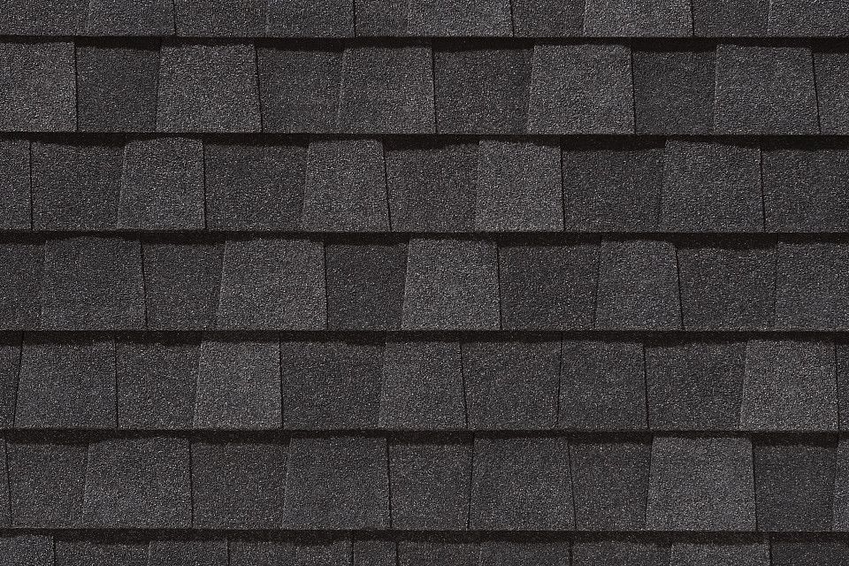 A close up of a black shingle roof.