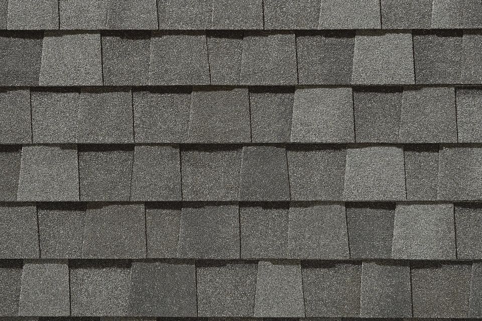 A close up of a roof with a lot of shingles on it.