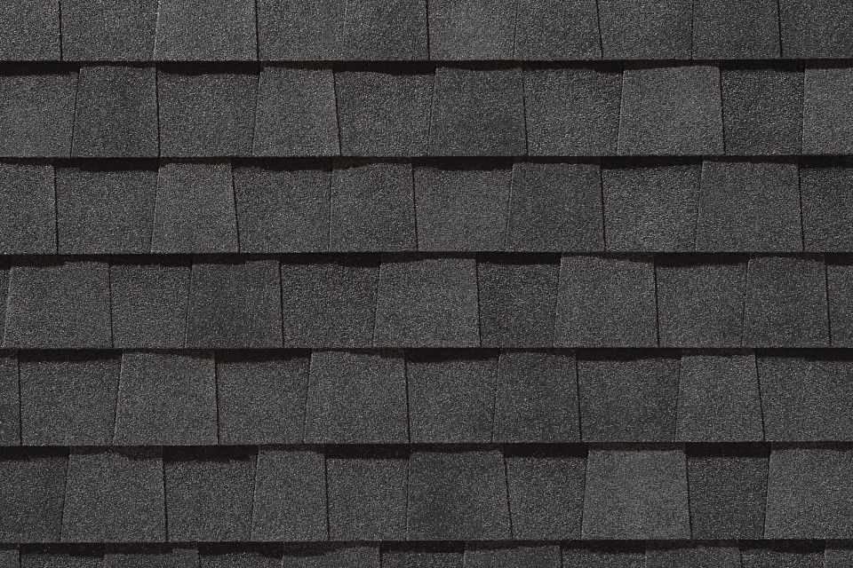 A close up of a black shingle roof.