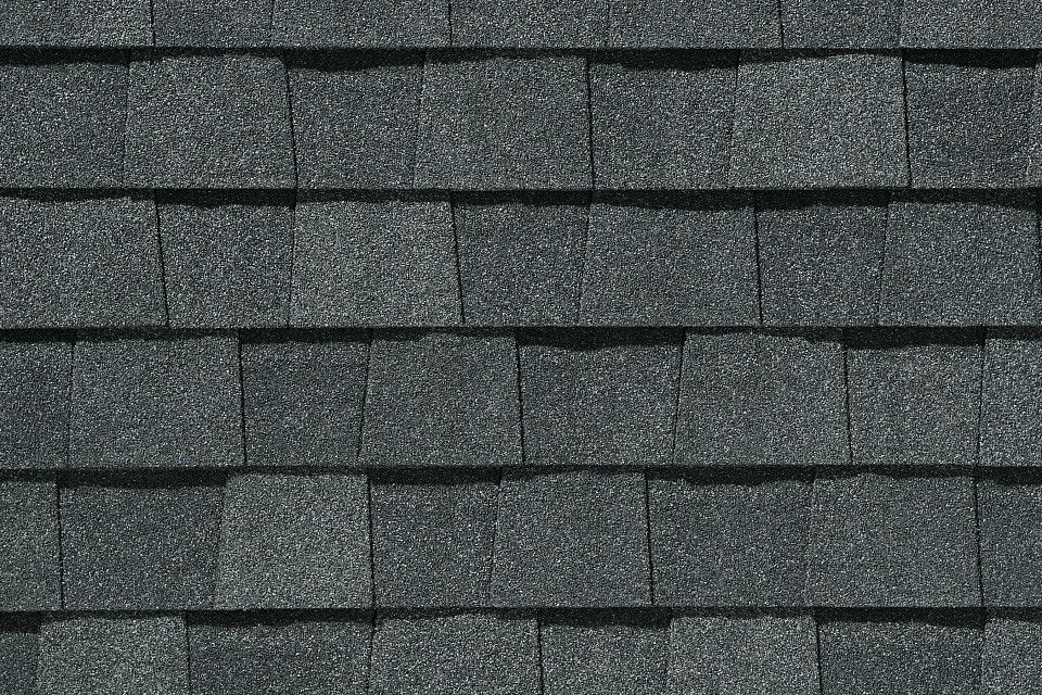 A close up of a roof with a lot of shingles on it.