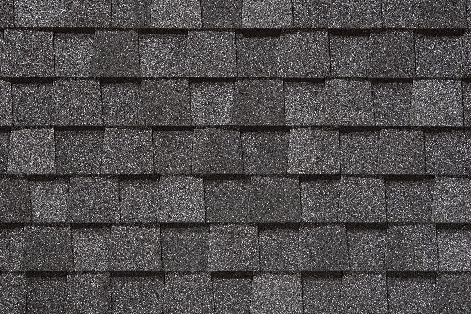 A close up of a roof with a lot of shingles on it.