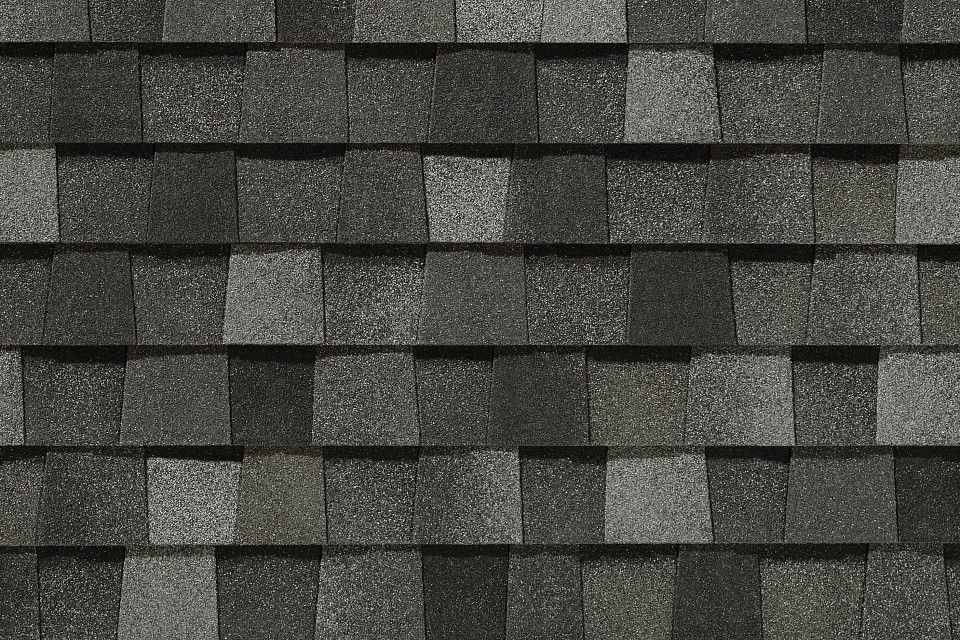 A close up of a roof with a lot of shingles on it.