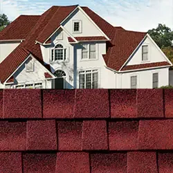 Red asphalt shingle roof on a white house with several gables and windows.
