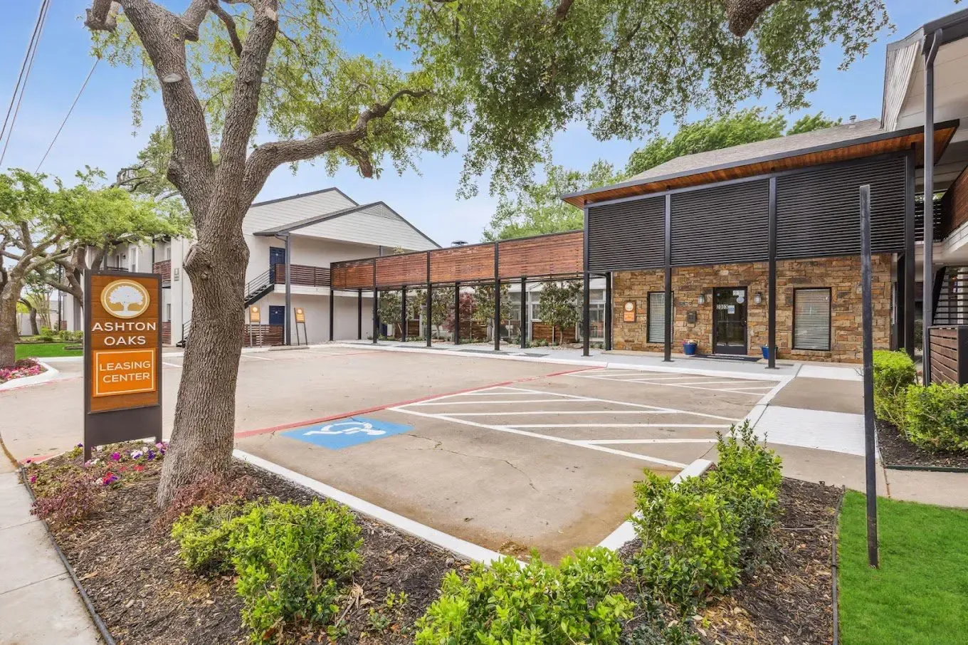 Exterior of office building with parking and sign.