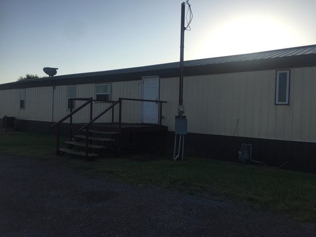 A mobile home with stairs leading up to it