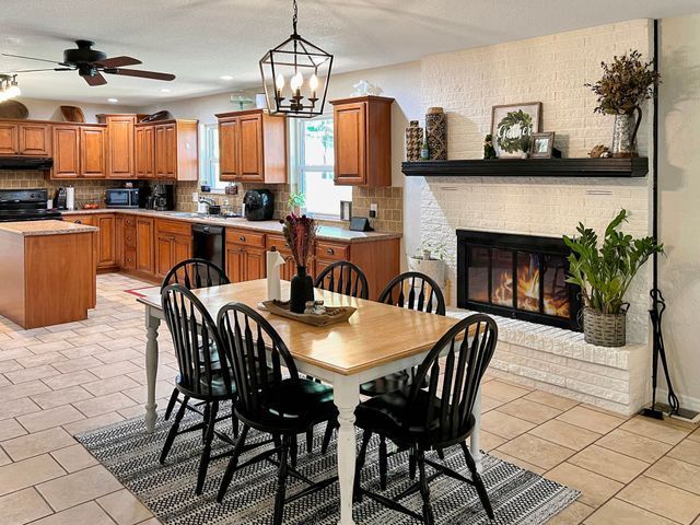 A kitchen with a table and chairs and a fireplace