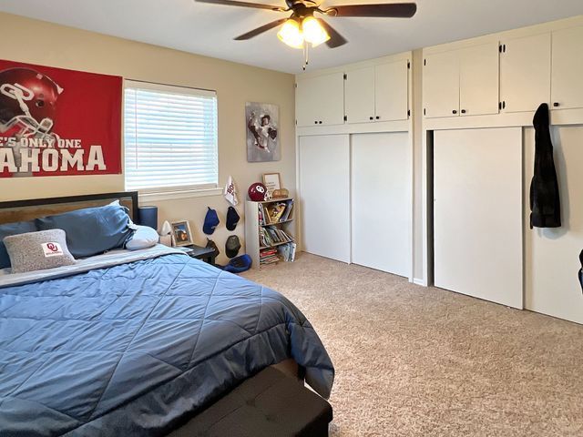 A bedroom with a bed and a sign that says oklahoma