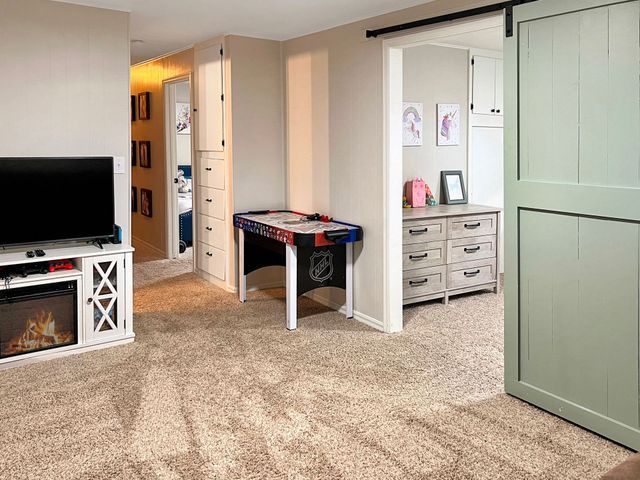 There is a game table in the middle of the room.