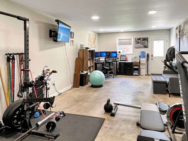 A large room with a lot of exercise equipment in it.