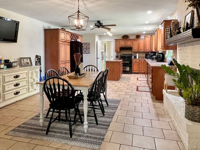 A kitchen and dining room in a house with a table and chairs.