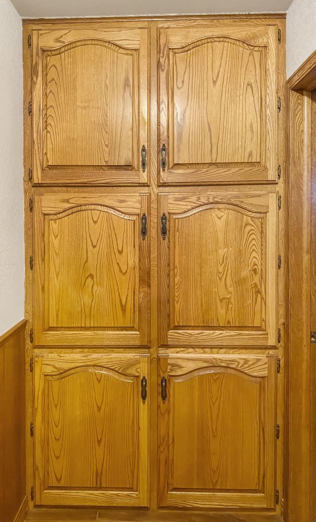 A close up of a wooden cabinet in a room.
