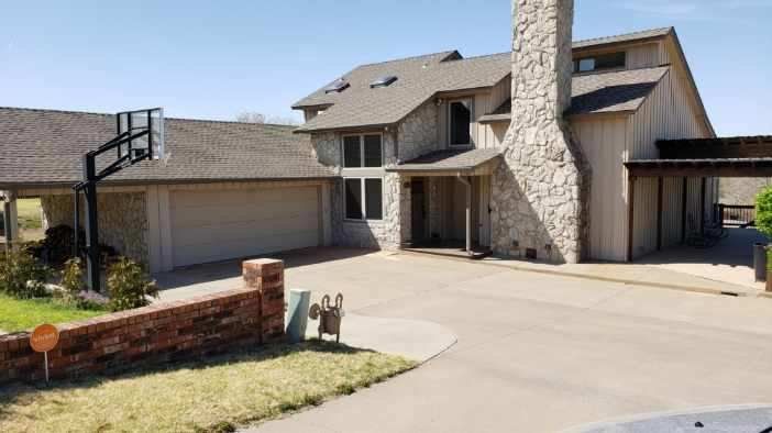 A large house with a basketball hoop in front of it.