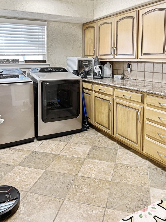 A kitchen with stainless steel appliances and wooden cabinets.