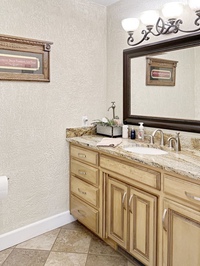 A bathroom with two sinks and a large mirror