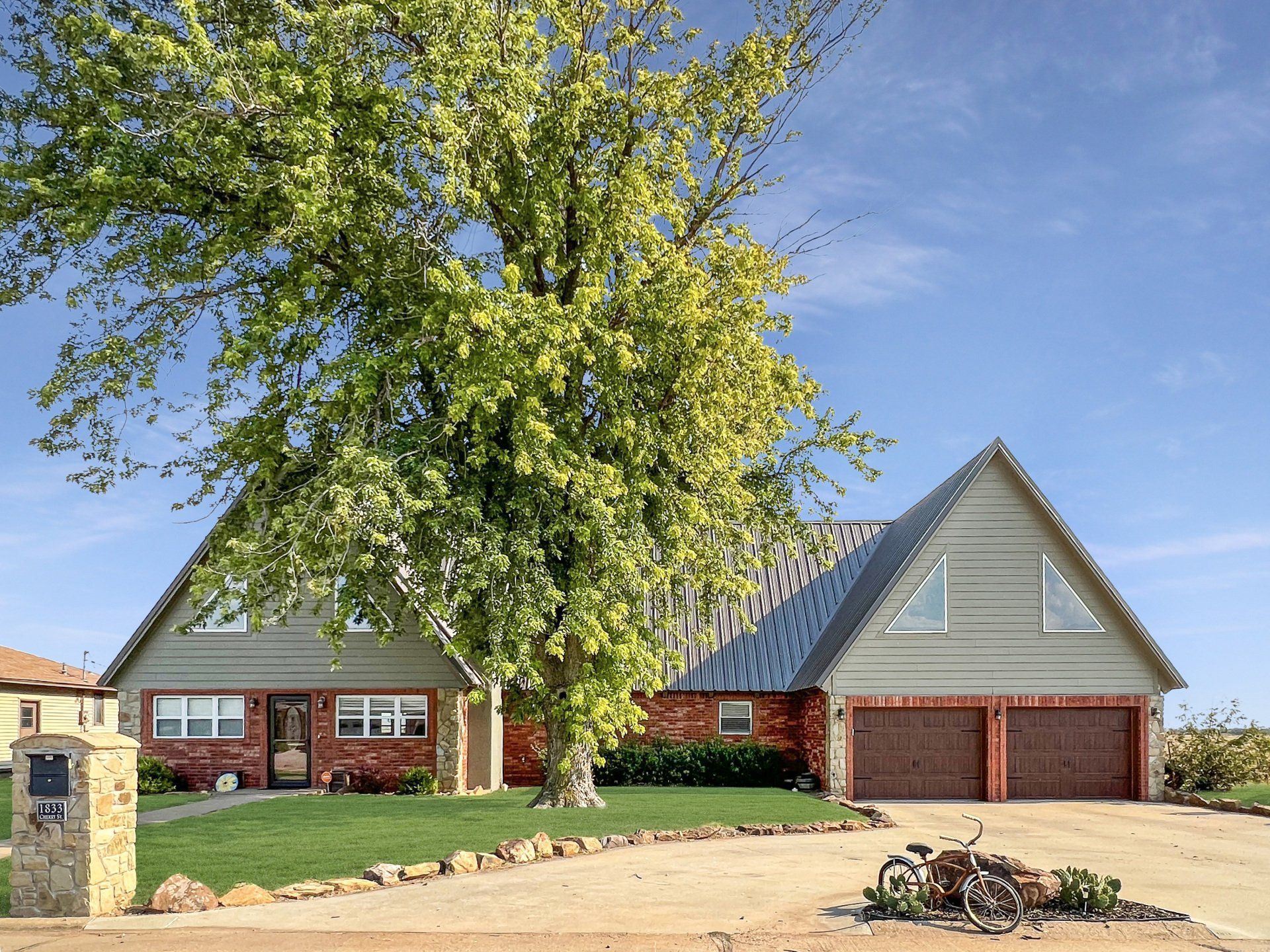 A house with a large tree in front of it