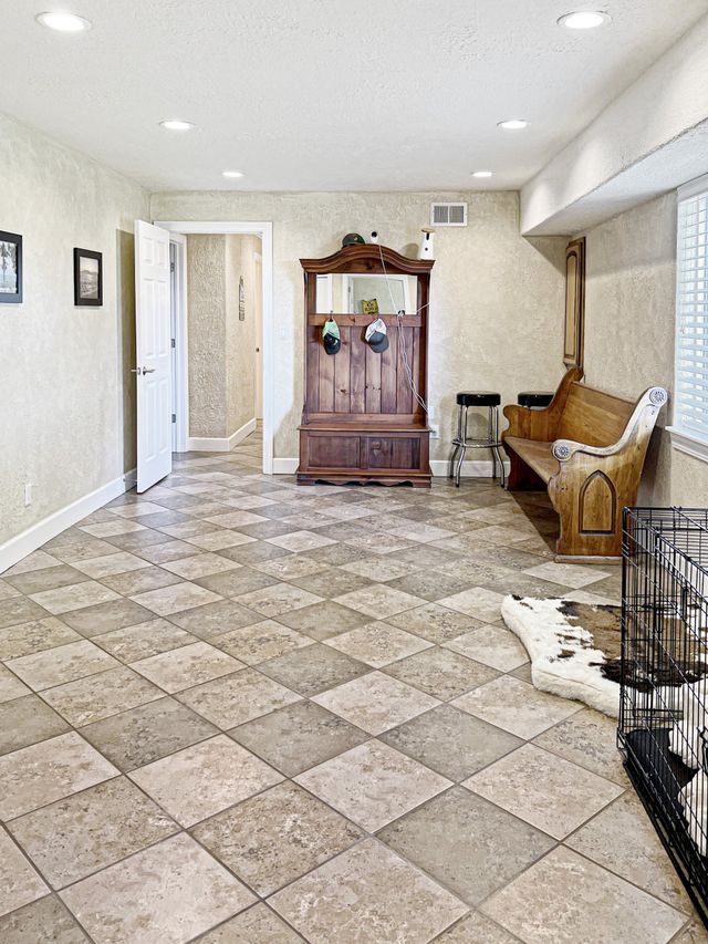 There is a dog cage in the middle of the room.