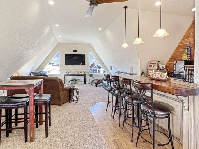 A living room with a bar and tables and chairs