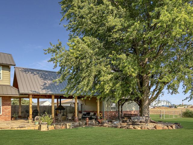 A house with a large tree in front of it